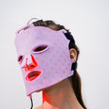 Light Therapy Face Mask worn on the face, glowing red